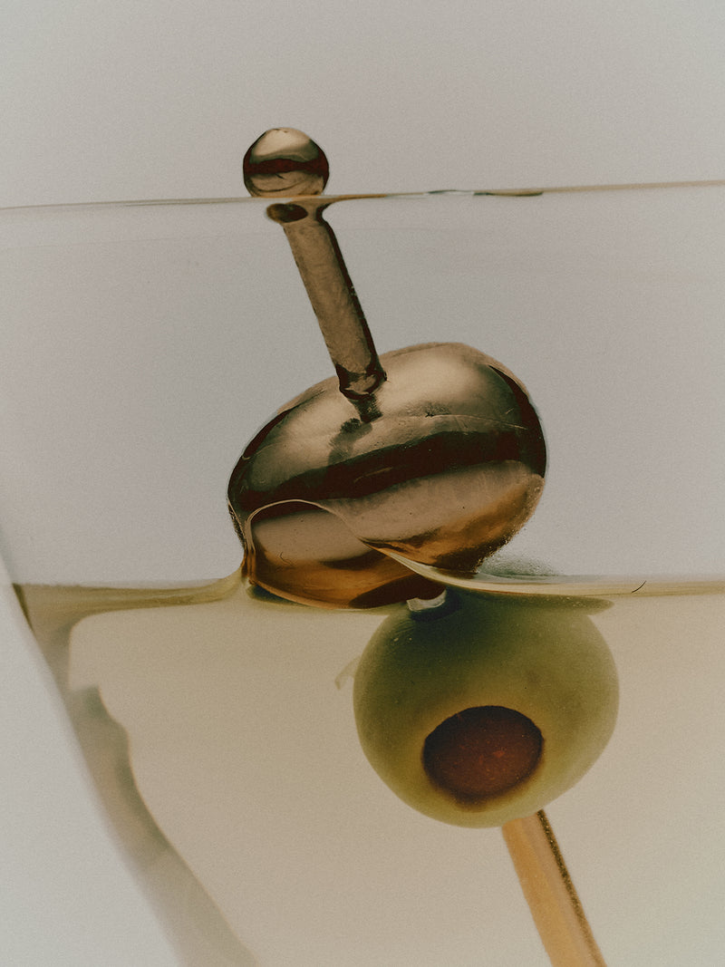 COREY ASHFORD olive cocktail pick in gold close up detail shot in dirty martini